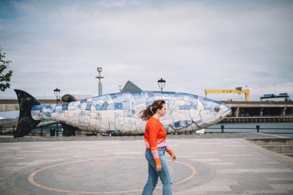 Student walking past the big fish