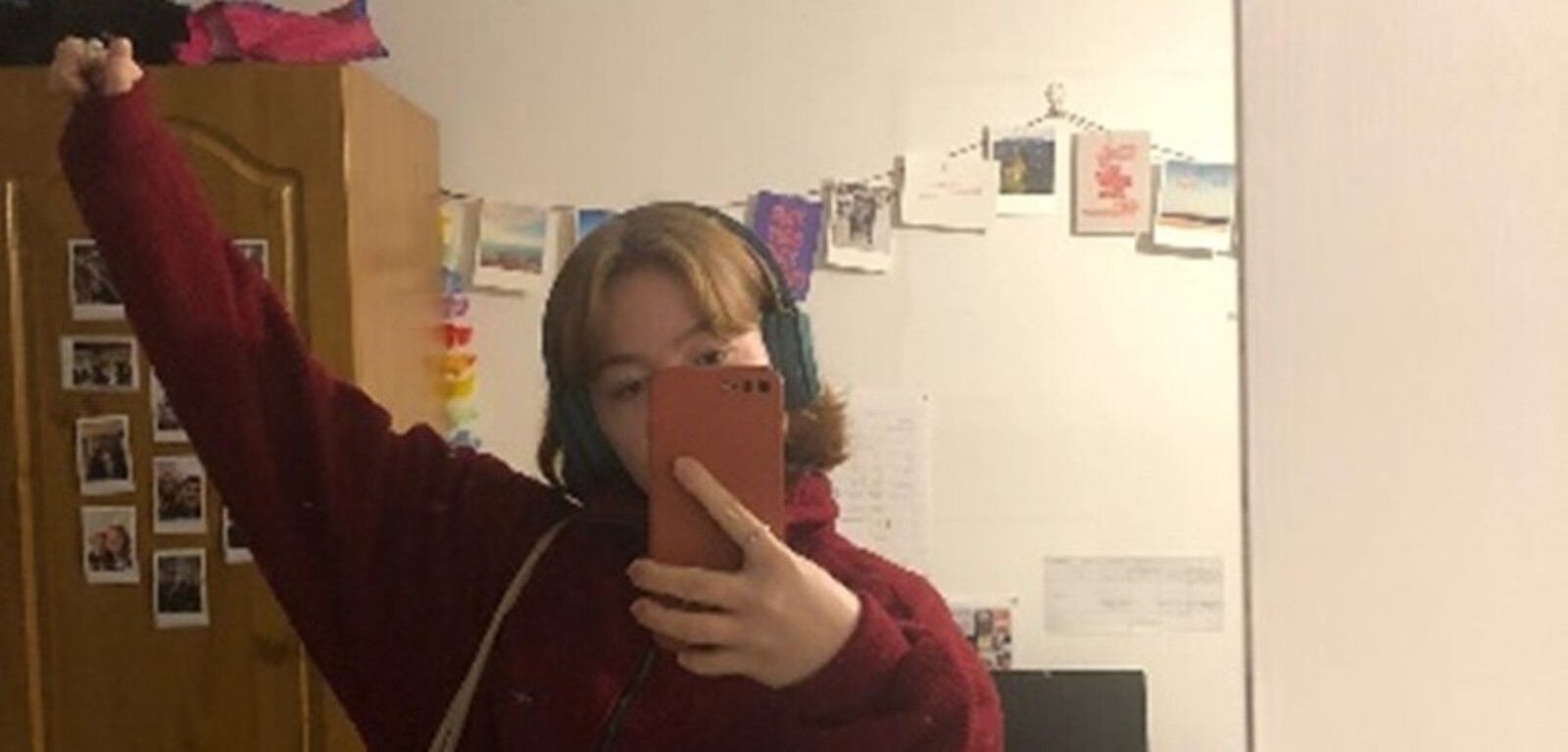 Student posing in their room