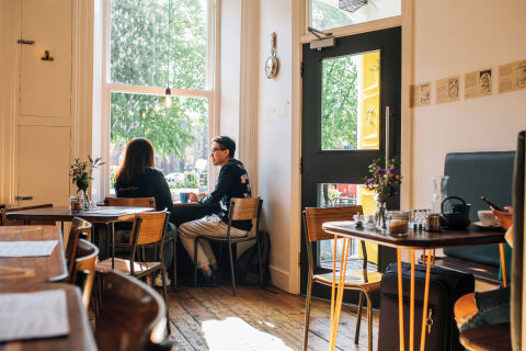 Two students sitting together in cafe