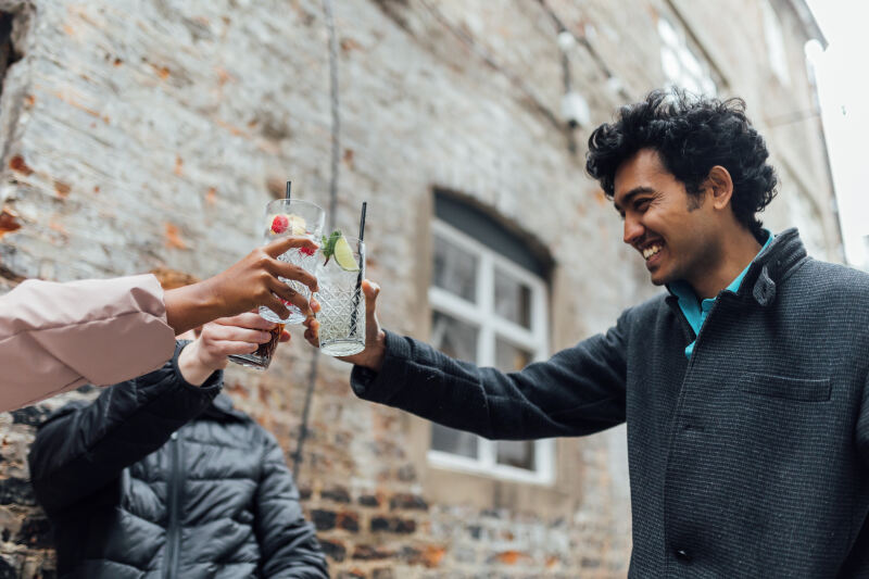 Three students toast drinks