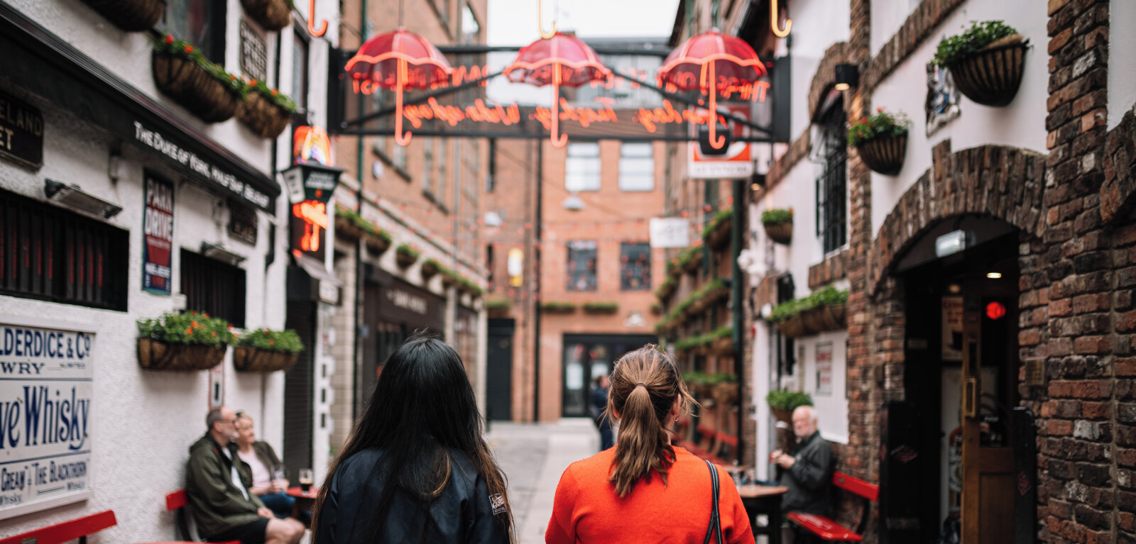 Two students walking down Commercial Court, Belfast