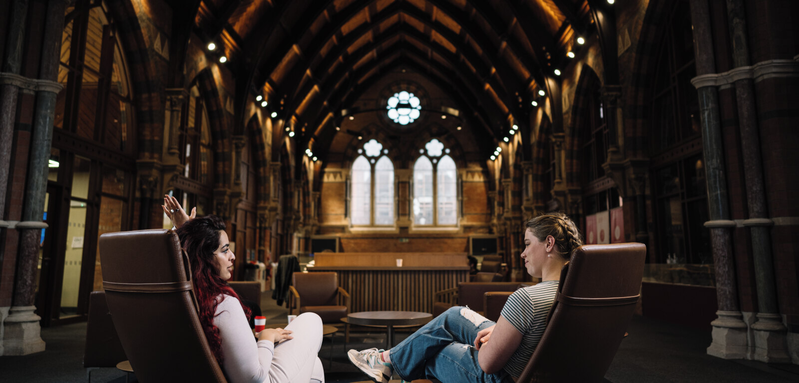 Two female students in the seating area of the Graduate School