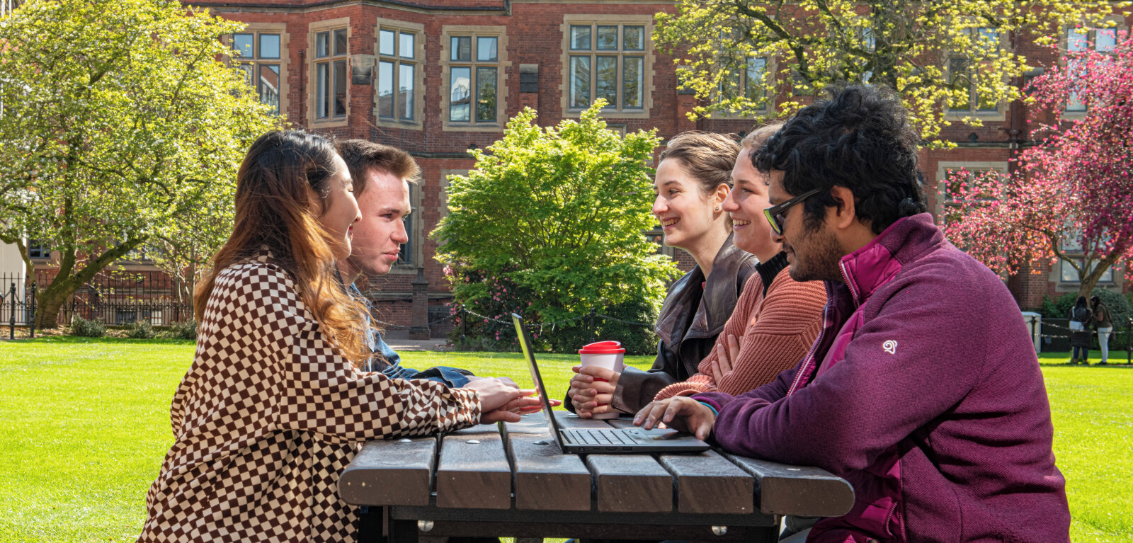 Students sitting on bench outside Junction cafe