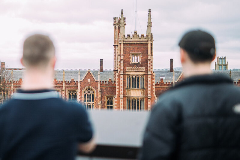 Two students facing the front of the Lanyon Building