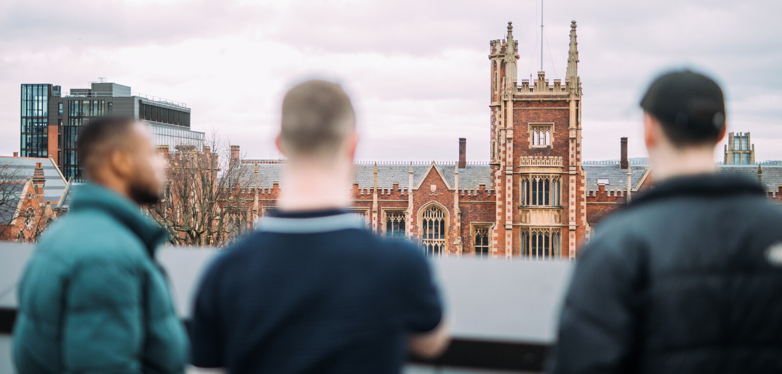 Three students looking at the Lanyon