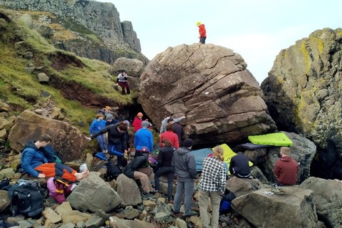 Group of students climbing mountain