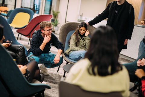 Group of students talking in One Elmwood