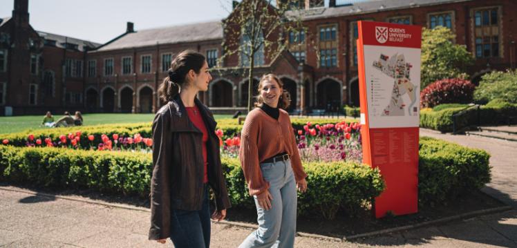 Two female students walking through the Quad