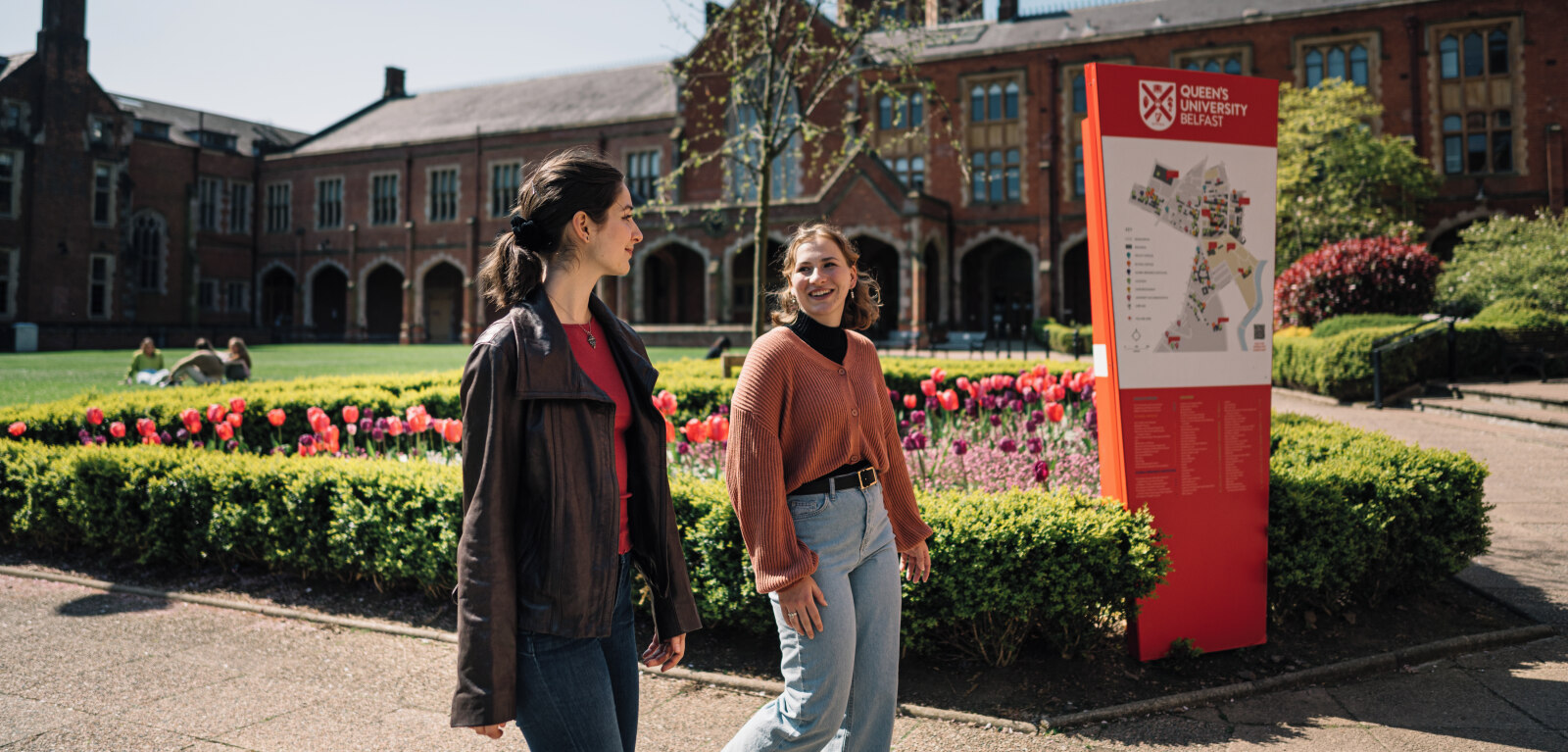 Two female students walking through the Quad