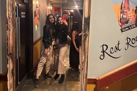 Two females posing in front of mirror in Revolucion de Cuba