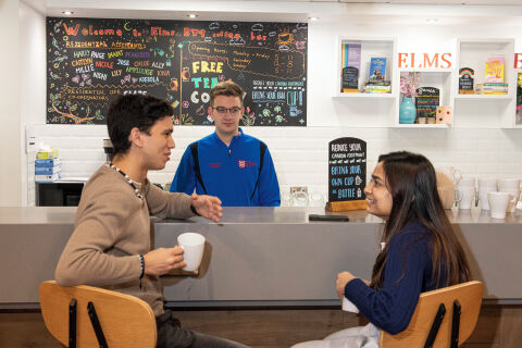 Two students talking at the coffee bar in the Treehouse, BT9