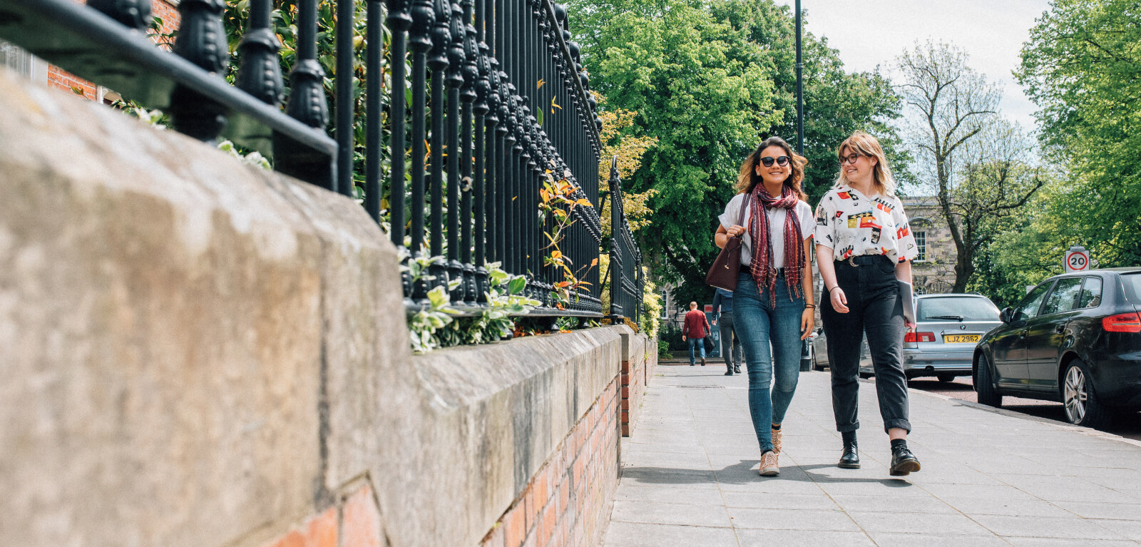 Two students walking through campus