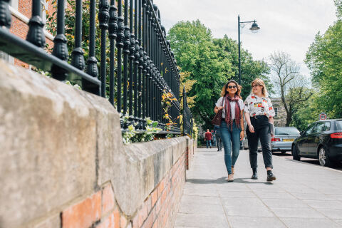 Two students walking on University Square
