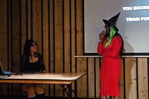 Student singing at Taylor Swift Halloween Karaoke event