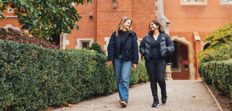 Students Tessa and Sanjana walk through the Quad