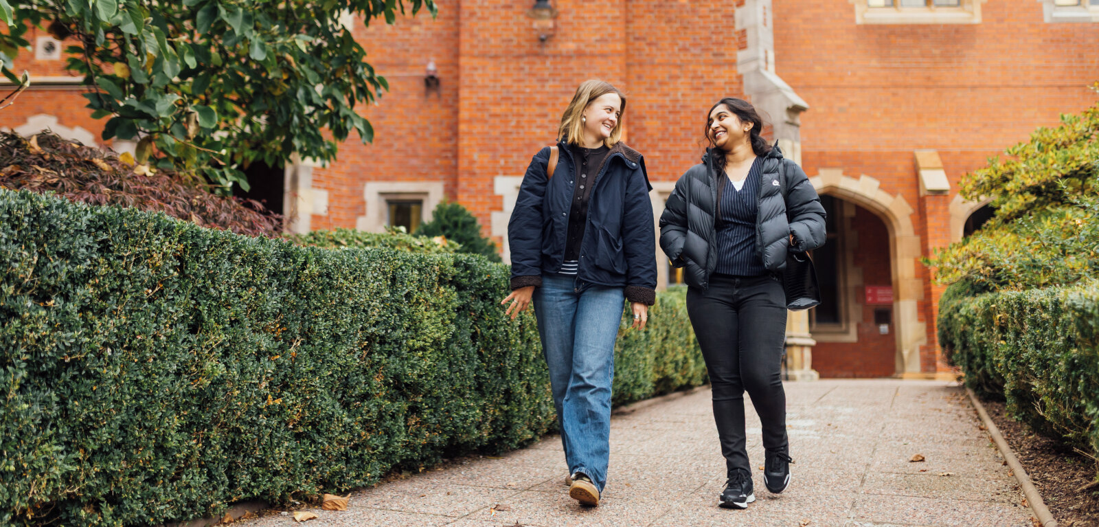Students Tessa and Sanjana walk through the Quad