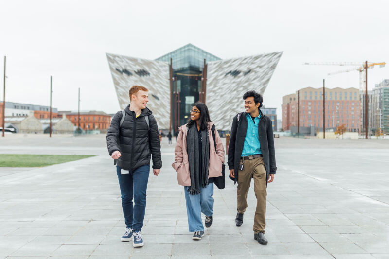 Three students walk down slipways with Titanic Museum in background