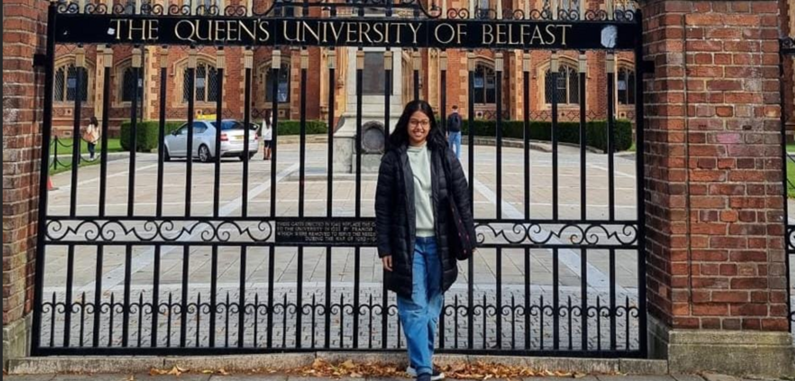Student Tista in front of Lanyon gates
