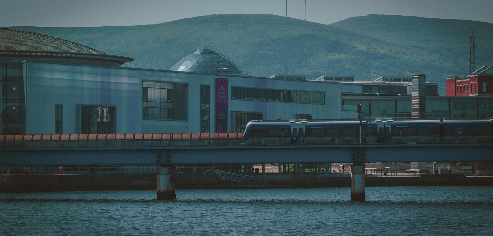 Train moving past Waterfront Hall