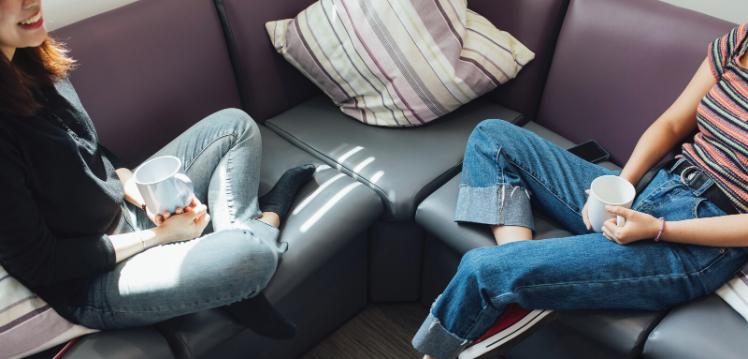 Two students sitting on sofa
