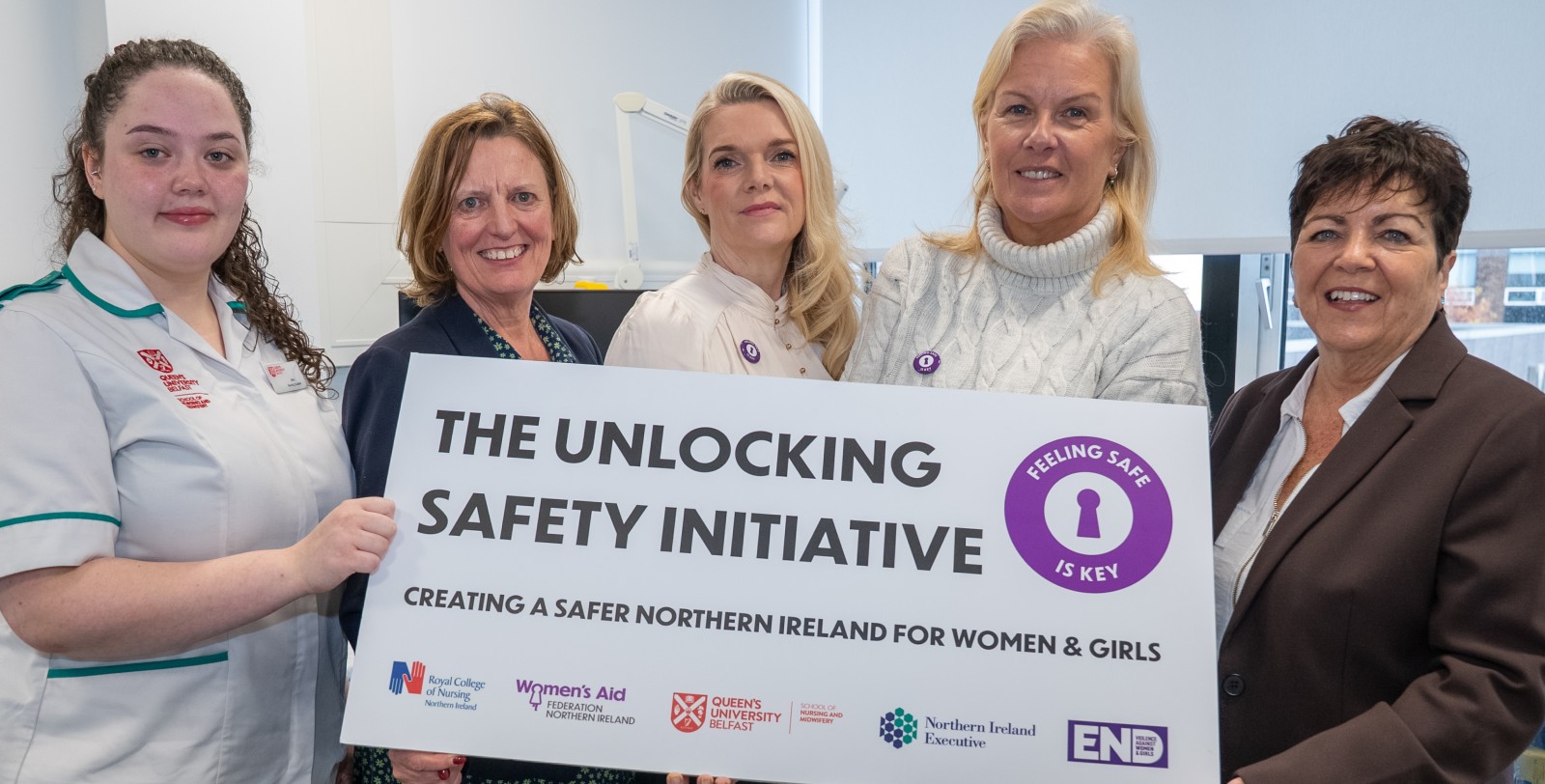 Women standing with a prop