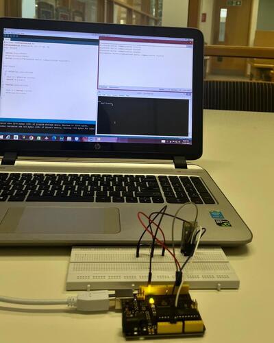 Electronics student's laptop and circuit board