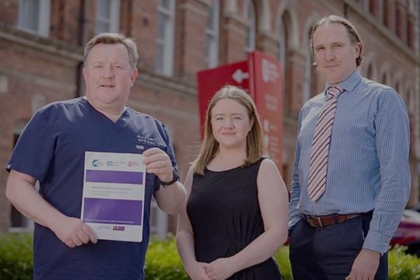 Researchers holding an audit report