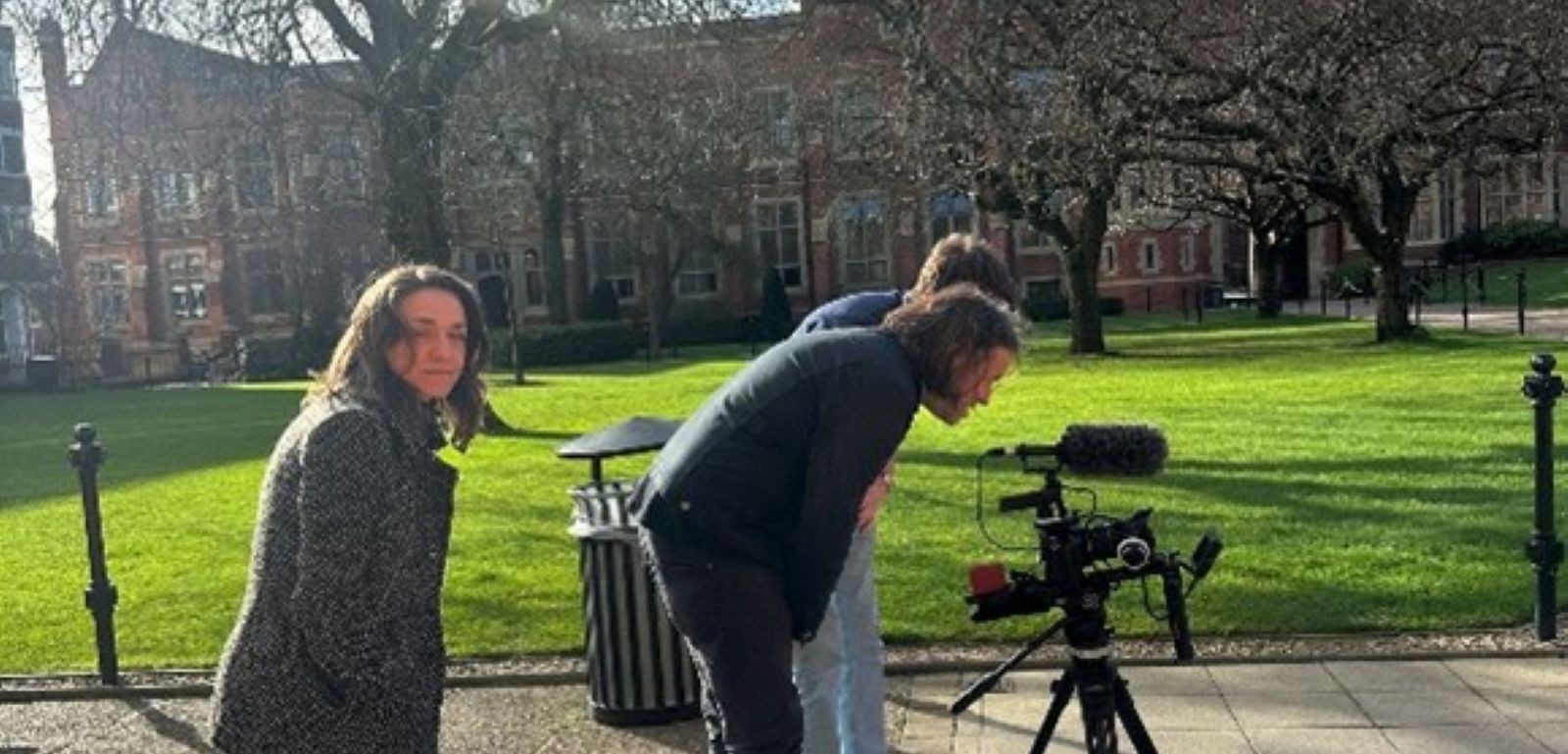 People using a film camera on Queen's campus