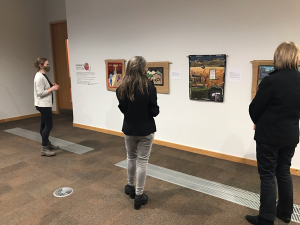 Lauren Dempster (QUB), Roberta Bacic (Conflict Textiles) and Paula Devine (ARK) (L-R) viewing the Conflict Textiles exhibition at the McClay Library. (Photograph: Gillian Robinson).