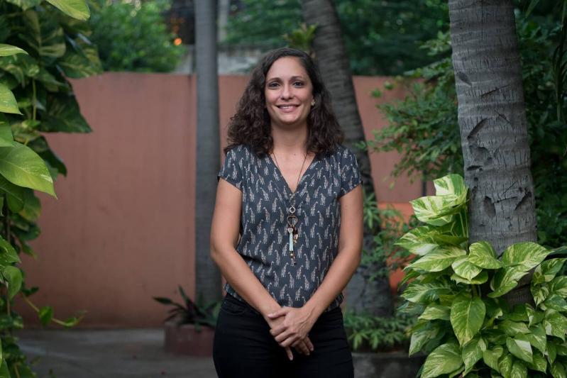 A woman standing beside a tree