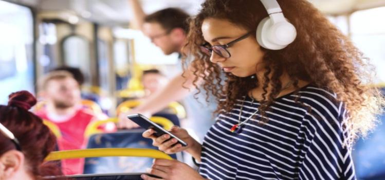 girl on public transport with headphones