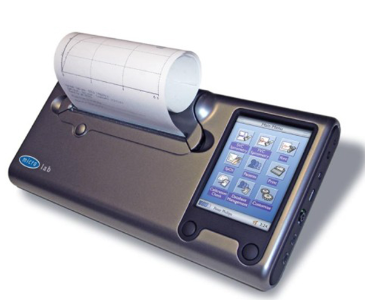 A picture of the Spirometer sitting against a white background with a print out of the readings.