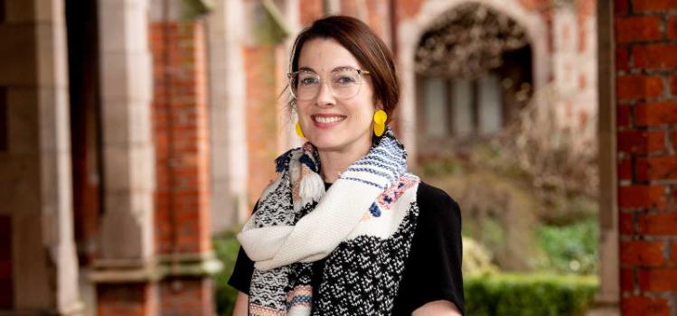 smiling woman with brown hair and glasses