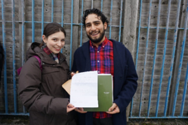 Niamh and Aruro holding up a piece of paper