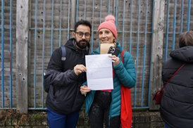 Selcuk and Alice holding up a piece of paper