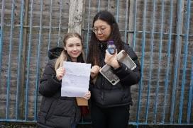 Amaria and Mihua holding up a piece of paper