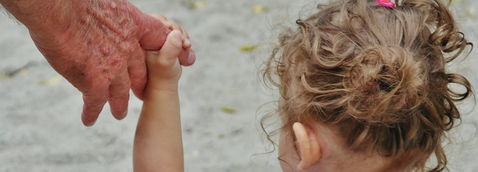 child holding adult by hand