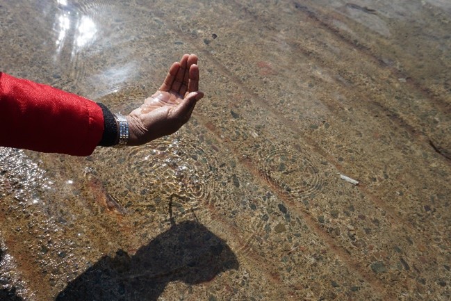 cupped hand above water