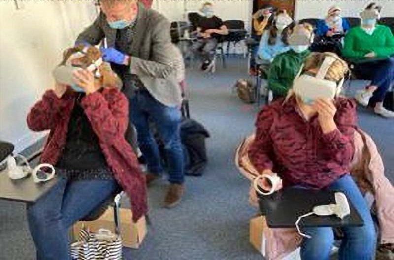 people in classroom using VR technology