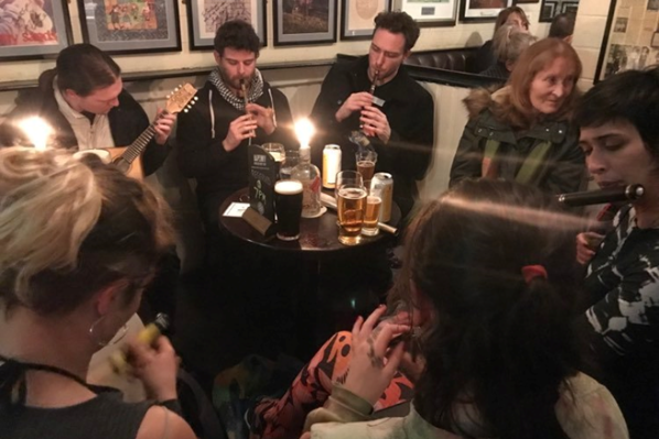 group of traditional Irish musicians playing at a pub