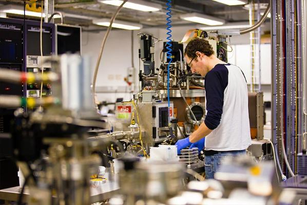 Postgraduate student in a room full of complex machinery