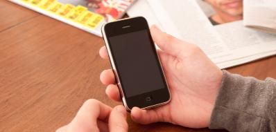 photo of a young person holding a phone (close up of hands)