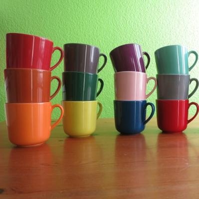 Four stacks of three cups each, one on top of the other, are shown in different colours 