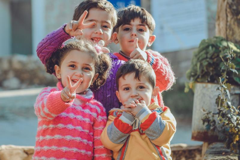 Four children, three boys and a girl pose for the camera