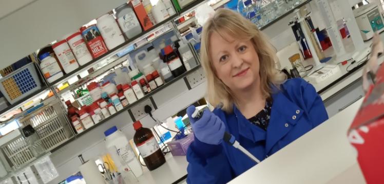 Dr Denise McDonald using a pipette in a laboratory