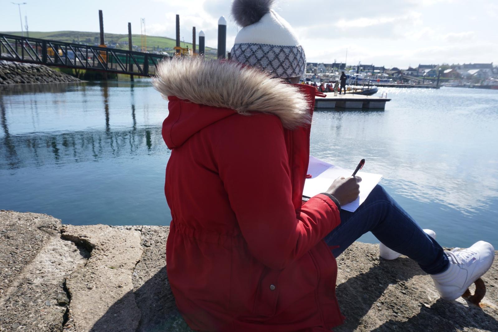 person looking out at water