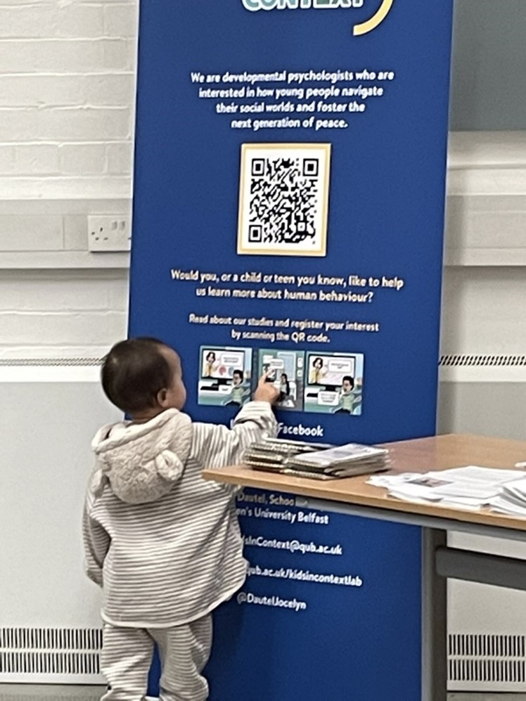 child looking at poster