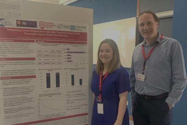 Researchers presenting a poster