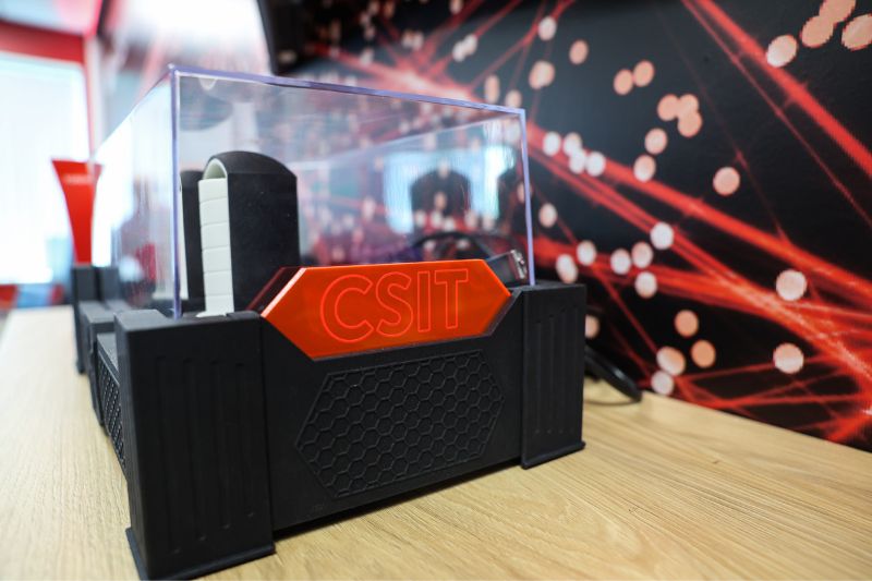 Close-up of CSIT research equipment with the CSIT logo in a lab environment at Queen’s University Belfast.