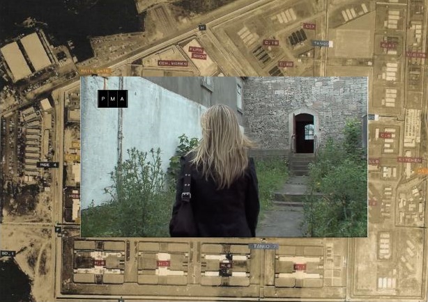 A women with long, straight, blond hair walking through the courtyard in Armagh Gaol. Her back is turned towards us.